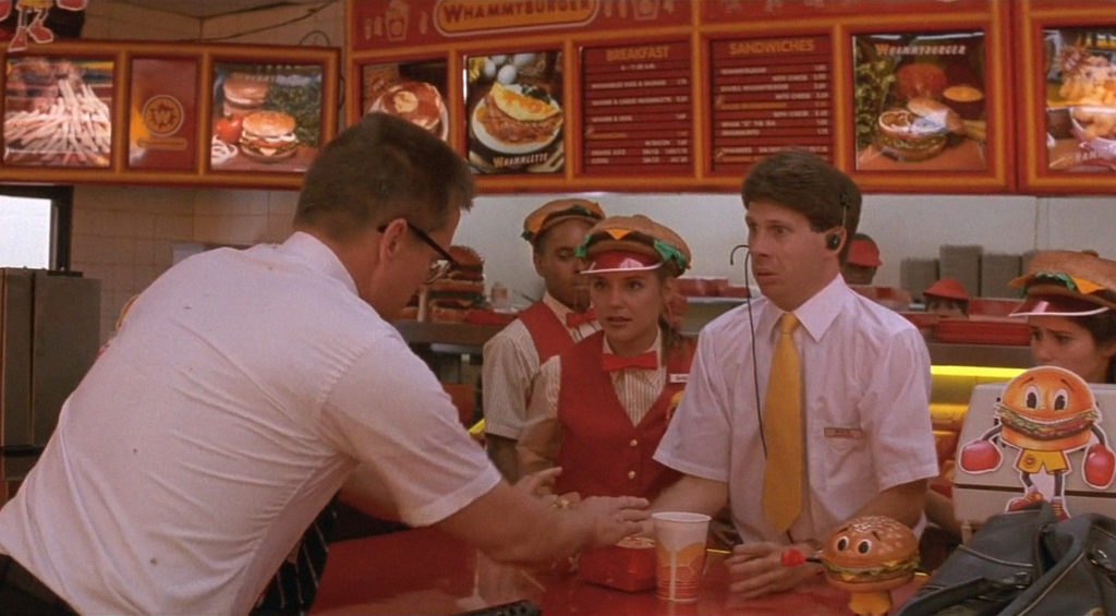 William Foster (Michael Douglas) reclamando do hambúrguer.