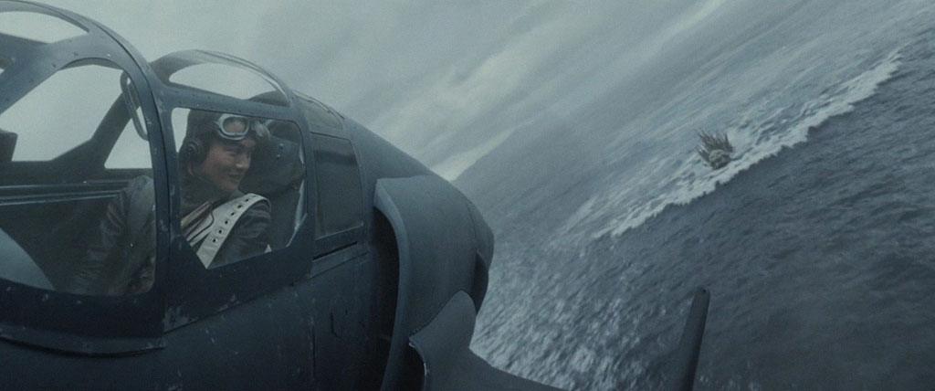 Shikishima sobrevoa Godzilla enquando o observa atraves do cockpit da aeronave.