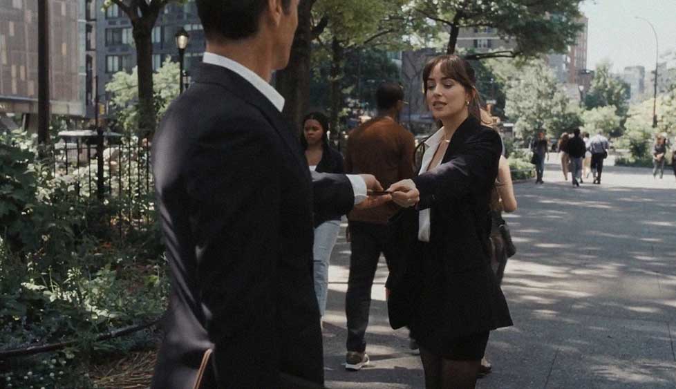 Lucy passar por um homem e volta para entregar a ele o seu cartão de visita e apresentar o seu serviço.